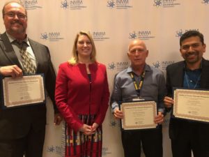 Dr. Chirayath with others receives the INMM Senior Membership Appointment certificate from INMM President, Corey Hinderstein