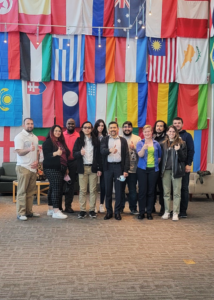 Group photo of students posing in ORNL flag room