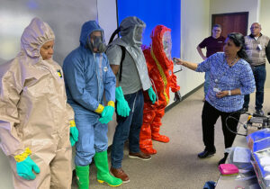 Vasudevan demonstrates levels of personal protective equipment required for radiological emergencies.