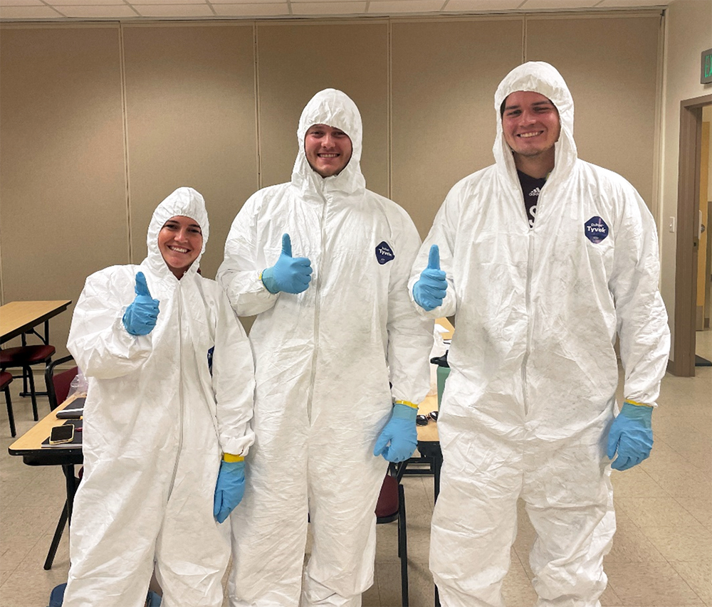 Texas A&M students Jordan Hillis, Maxwell Koester, and Camden Ulteig prepare to enter the contaminated zone to learn from the NEST team about working and taking samples in a contaminated enviroment.